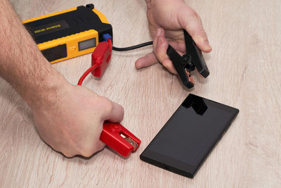 High angle view of man using mobile phone on table