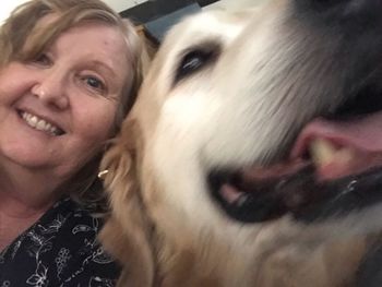 Close-up portrait of smiling woman with dog