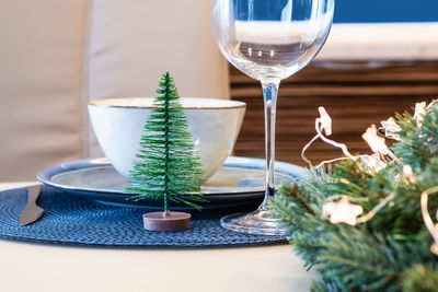 Christmas festive table decoration with spruce wreath and stars garland. blue color in interior