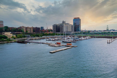 Scenic view of river by buildings against sky