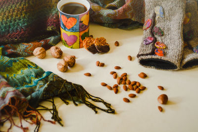 High angle view of hot chocolate drink and scarfs on table at home