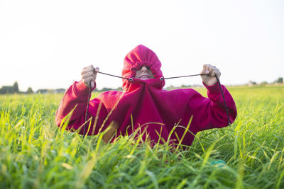 Rear view of woman standing on field