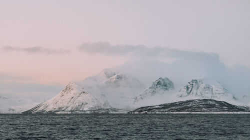 Scenic view of snowcapped mountains against sky during winter