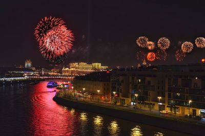 Firework display over river at night