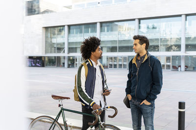 Two casual businessmen meeting in the city, barcelona, spain