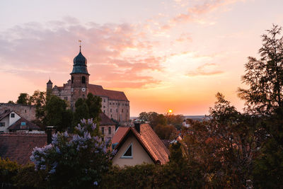 Buildings against sky at sunset