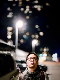 Portrait of young man with illumination at night.