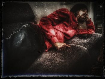 High angle view of woman sleeping on sofa