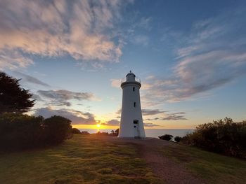 Mersey lighthouse by sea against sky during sunset in devonport, tasmania, australia.