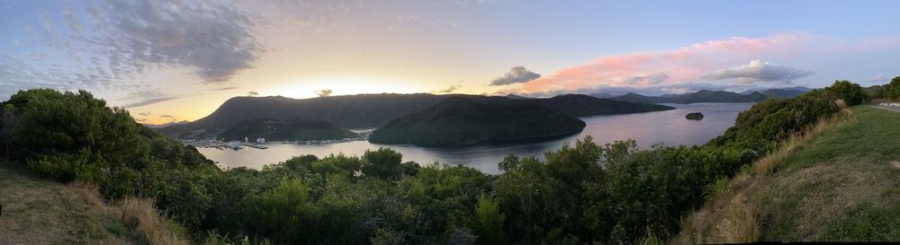 Panoramic view of sea and mountains against sky during sunset