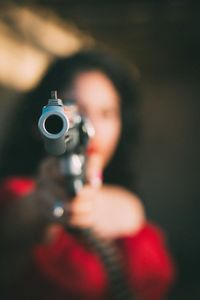 Blurred woman holding gun