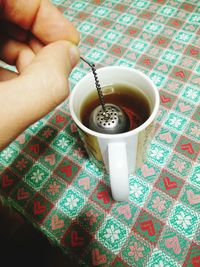 Close-up of cropped hand holding coffee