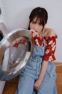 Portrait of smiling young woman drinking water