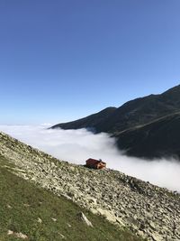 Scenic view of mountains against clear blue sky