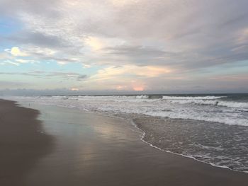 Scenic view of beach against sky during sunset