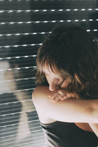 Close-up of woman sitting by window