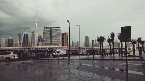 Skyscrapers against cloudy sky