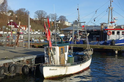 Fishing boats moored at harbor