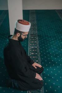 High angle view of man sitting on chair