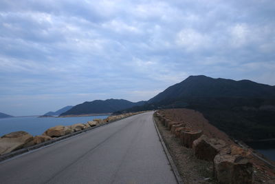 Road by sea against sky