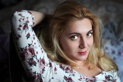 Portrait of beautiful woman with hand in hair at home