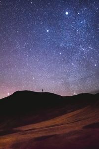 Scenic view of landscape against sky at night