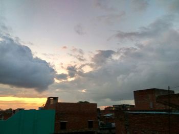 High section of building against sky at sunset