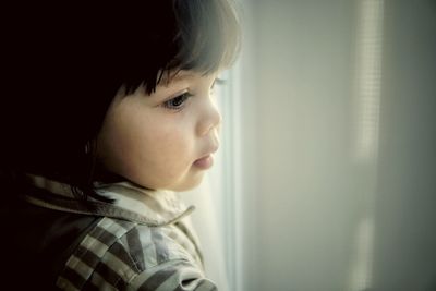 Portrait of cute girl looking away at home