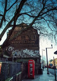 Low angle view of text on building against sky