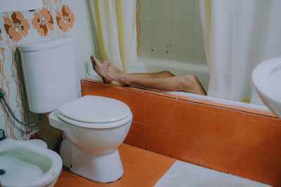 Low section of woman in bathtub