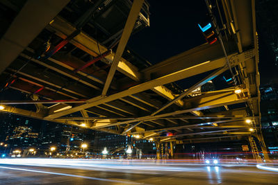 Illuminated light trails on road in city at night