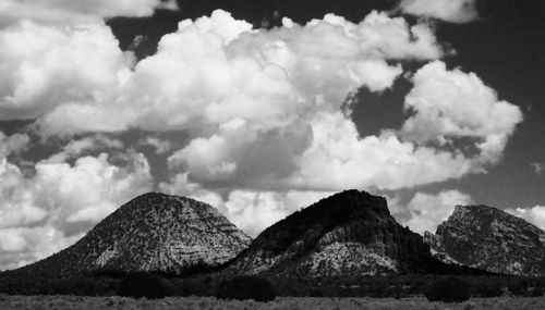 Scenic view of mountains against cloudy sky