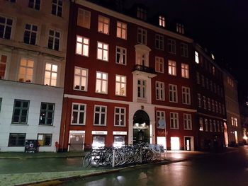 Reflection of illuminated building in city at night