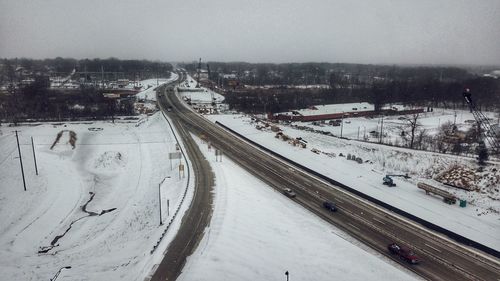 High angle view of snow covered road in city