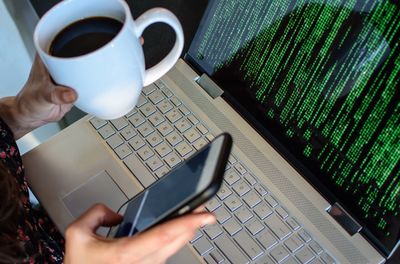 Midsection of man using mobile phone