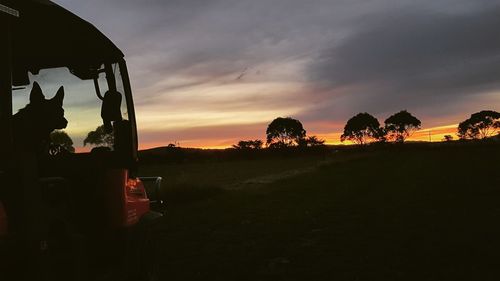 Scenic view of silhouette field against sky during sunset