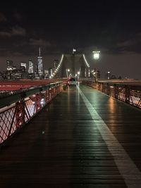 Illuminated bridge over river at night