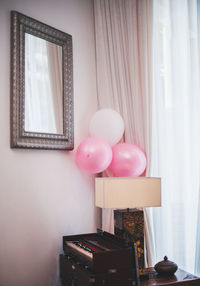 Multi colored balloons on table at home