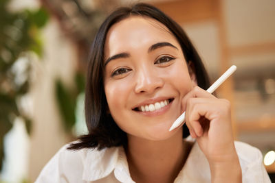 Portrait of young woman using mobile phone