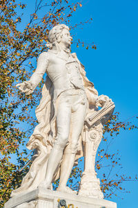 Low angle view of statue against blue sky