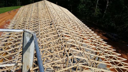 High angle view of metal structure on field in forest