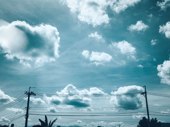 Low angle view of electricity pylon against sky