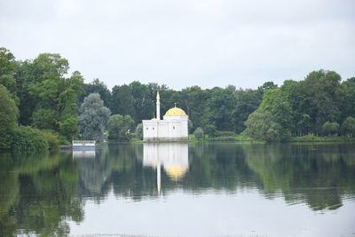 Reflection of trees in lake against sky