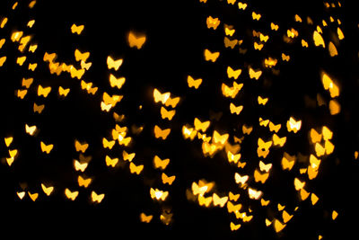 Defocused image of illuminated christmas lights at night