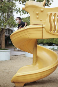 Portrait of kid in playground, wearing mask