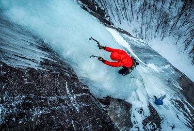 Man ice climbing on cathedral ledge in north conway, new hampshire