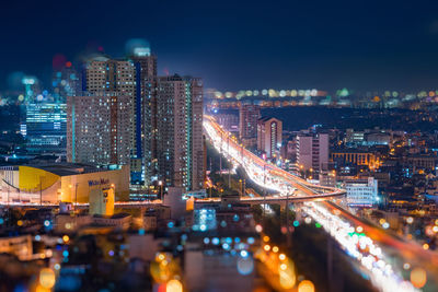 High angle view of illuminated buildings in city at night