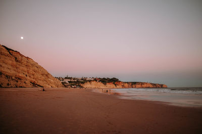 Scenic view of beach against sky during sunset