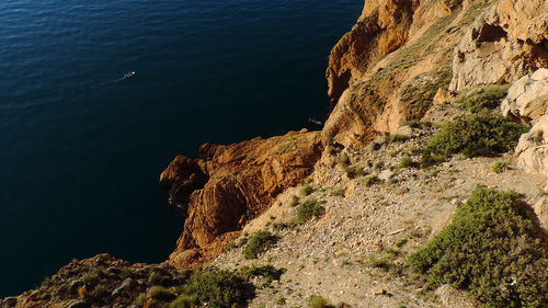 High angle view of rock formations by sea