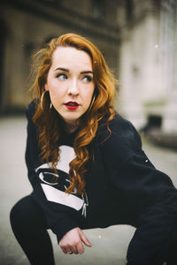 Portrait of young woman sitting outdoors